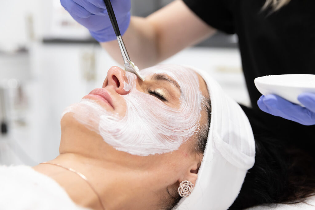 a woman receives a professional skin treatment after searching