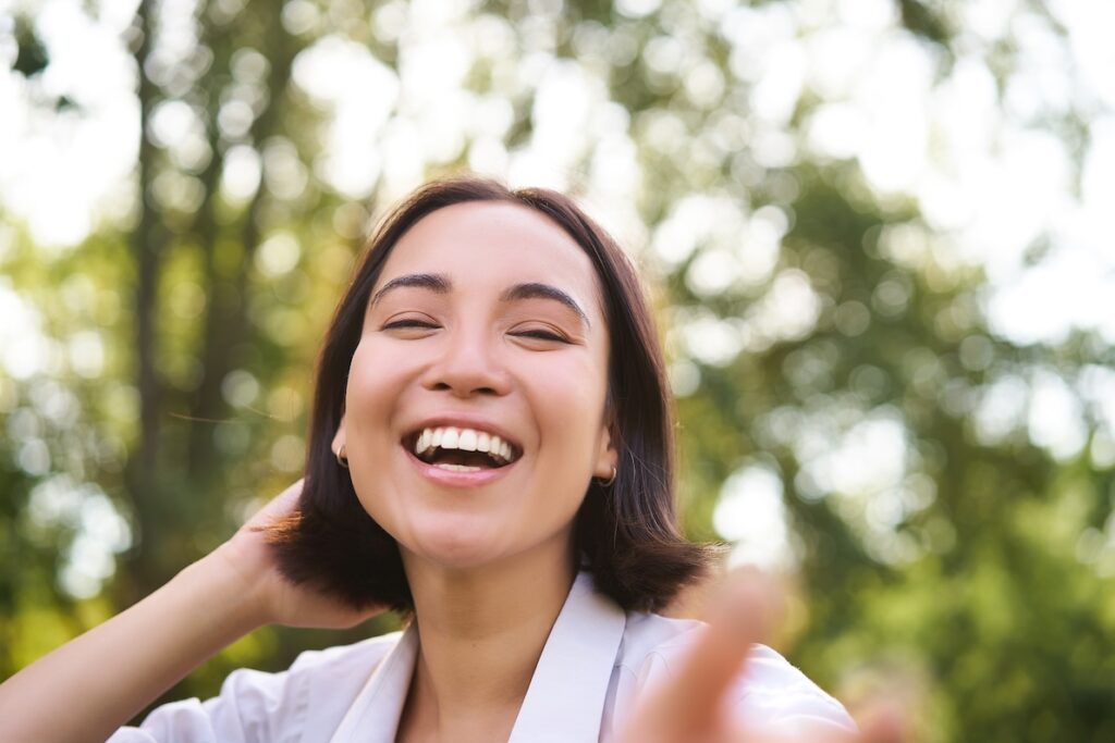 Woman smiles and feels her best after receiving peptide therapy near Buckhead