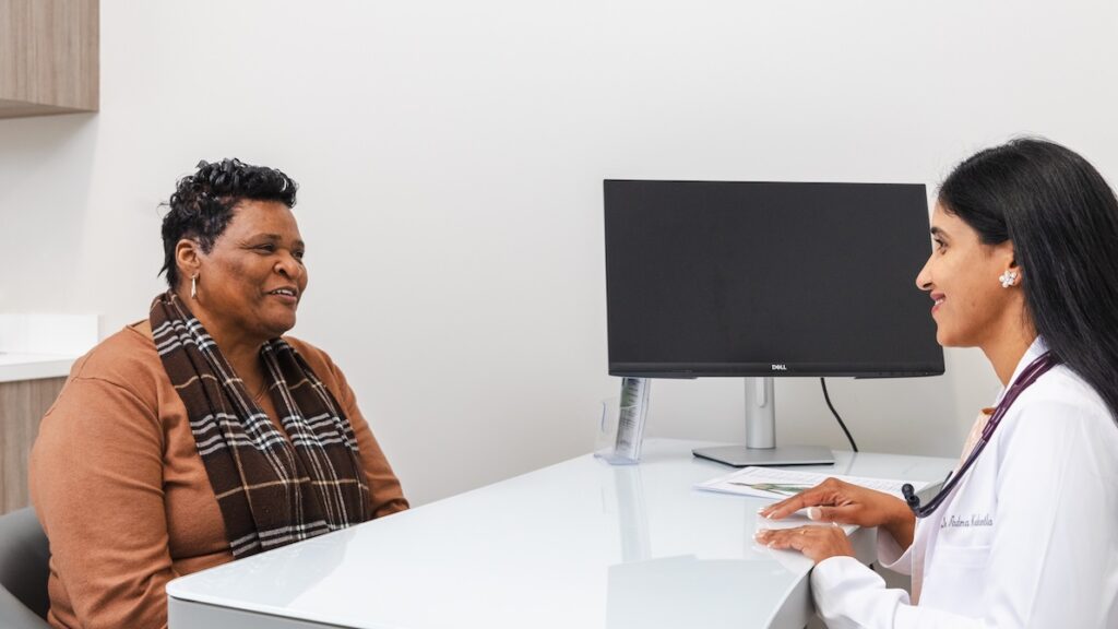 A WellnestMD provider discusses the options for cellulite treatment near Brookhaven with a patient in their consultation room.